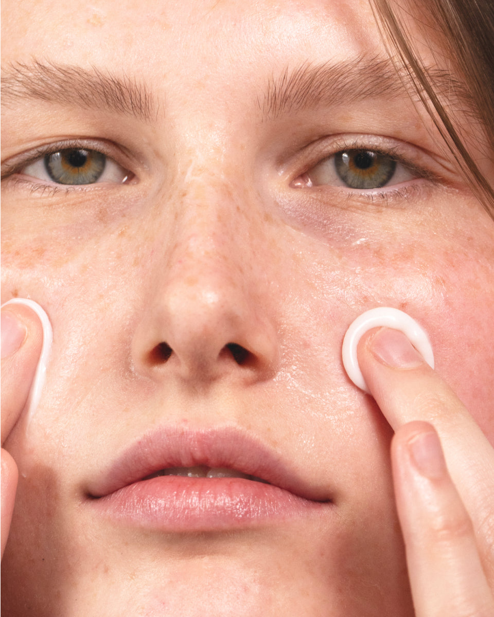 Model applying MÁDARA Derma Collagen Peptide Day Cream to face — deeply hydrating organic moisturizer with peptides for plump, voluminous, and supple skin