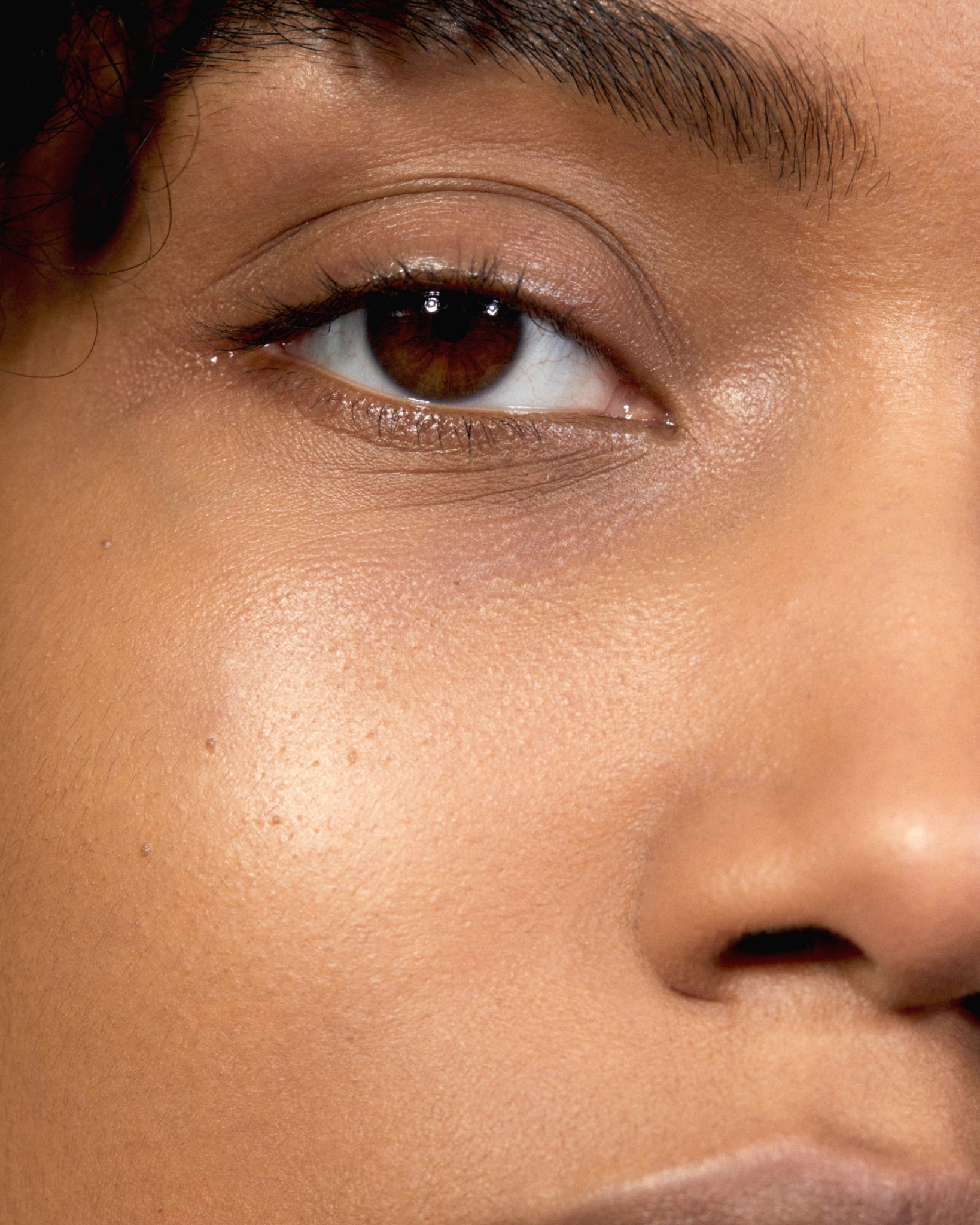 Model wearing MÁDARA Organic Skincare the concealer pine on A6114 concealer on skin; close-up portrait shows natural application results.