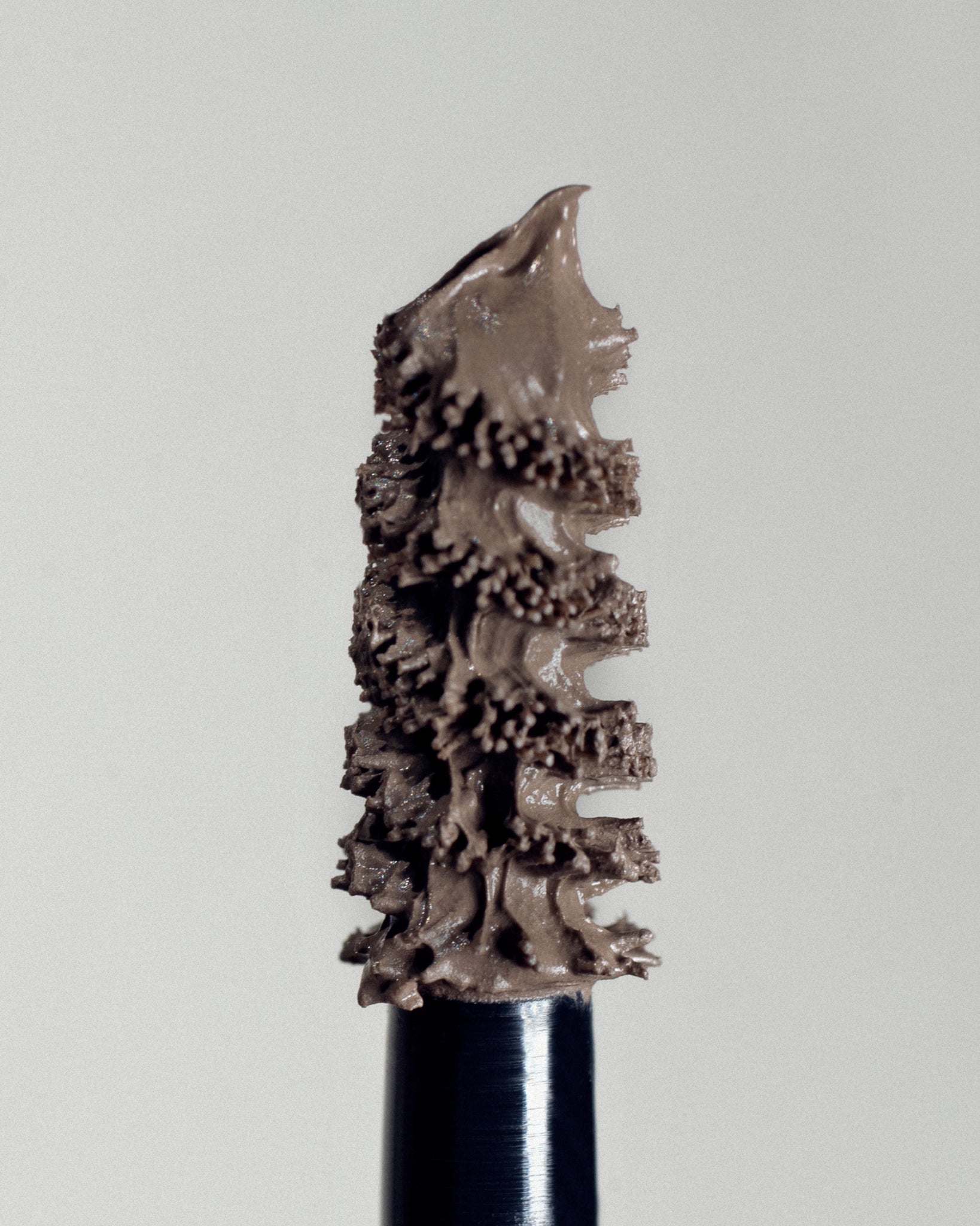 Texture close-up of MÁDARA Organic Skincare grow and fix frosty taupe A6703 �swatch demonstrates consistency and finish.