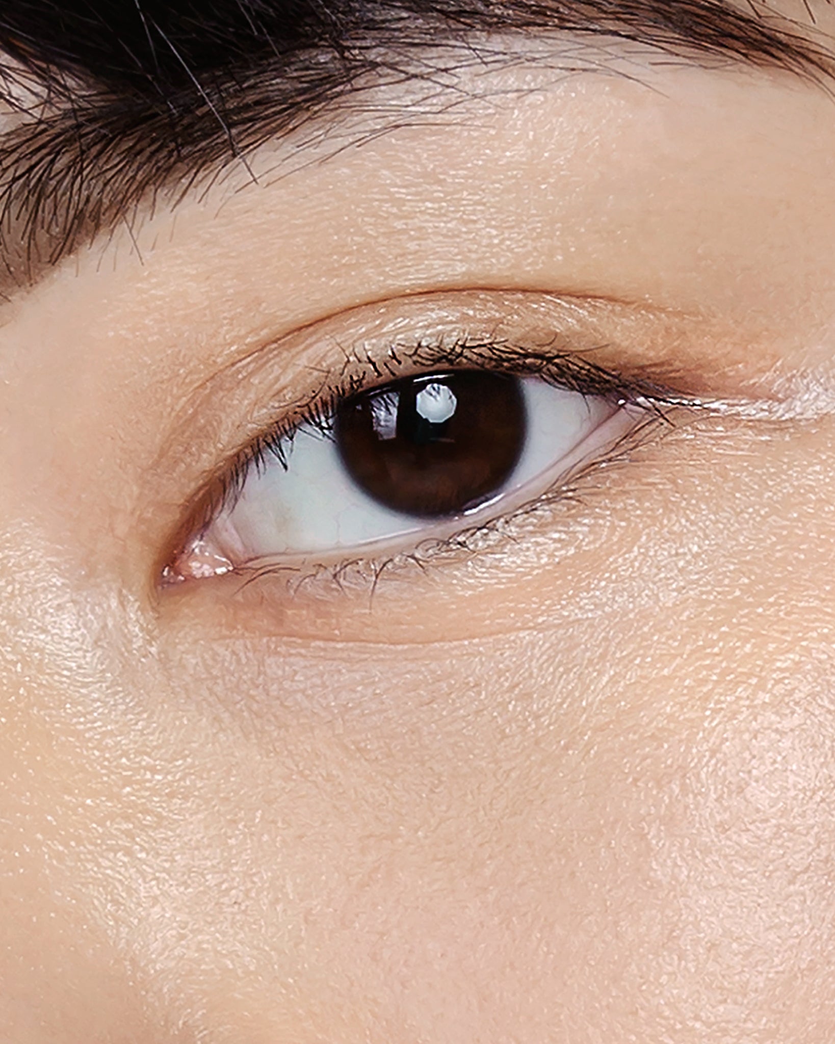 Model wearing MÁDARA Organic Skincare the concealer honey on A6102 concealer on skin; close-up portrait shows natural application results.