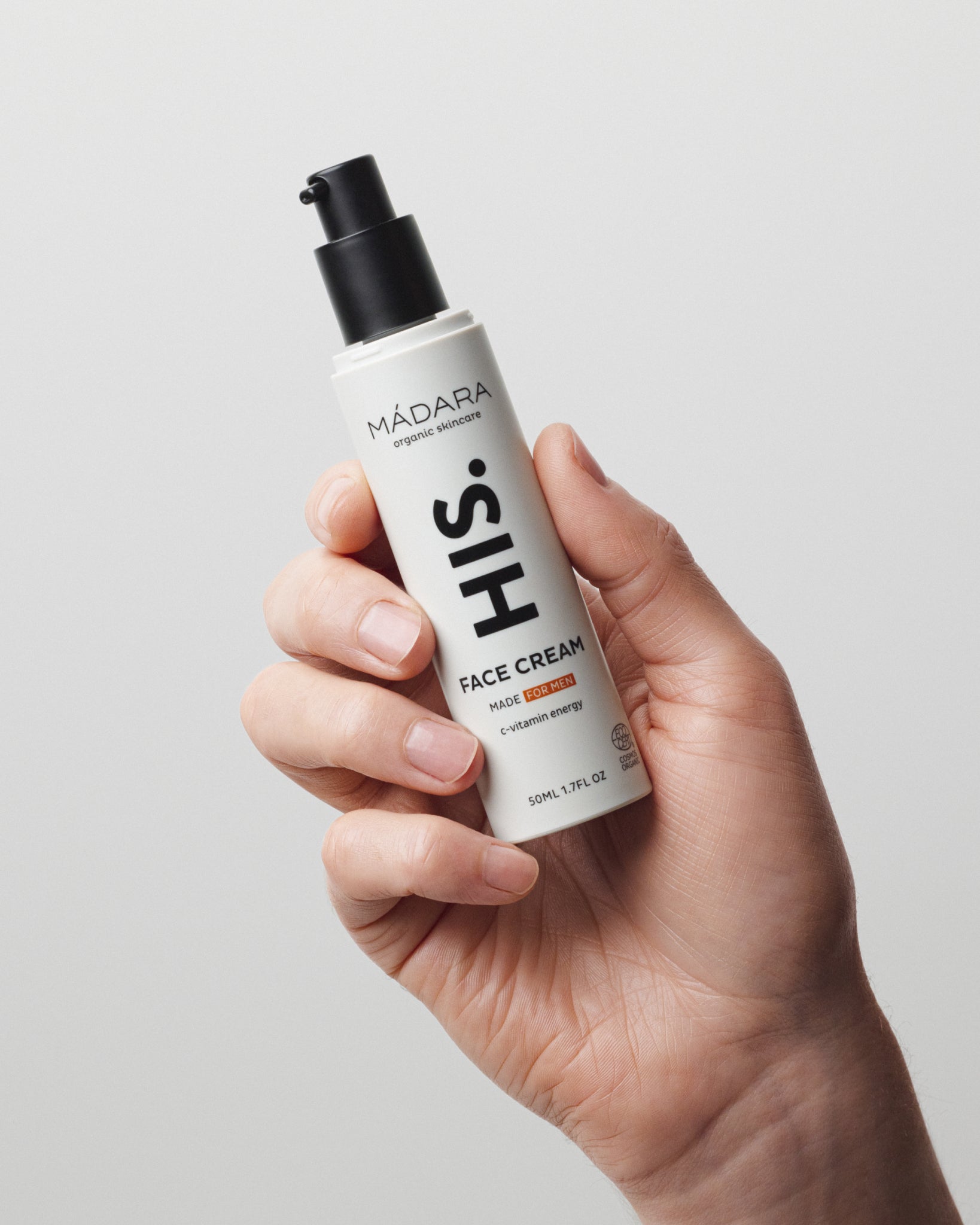 Model wearing MÁDARA Organic Skincare face cream made for men vitamin c A5003 face cream on skin; close-up portrait shows natural application results.